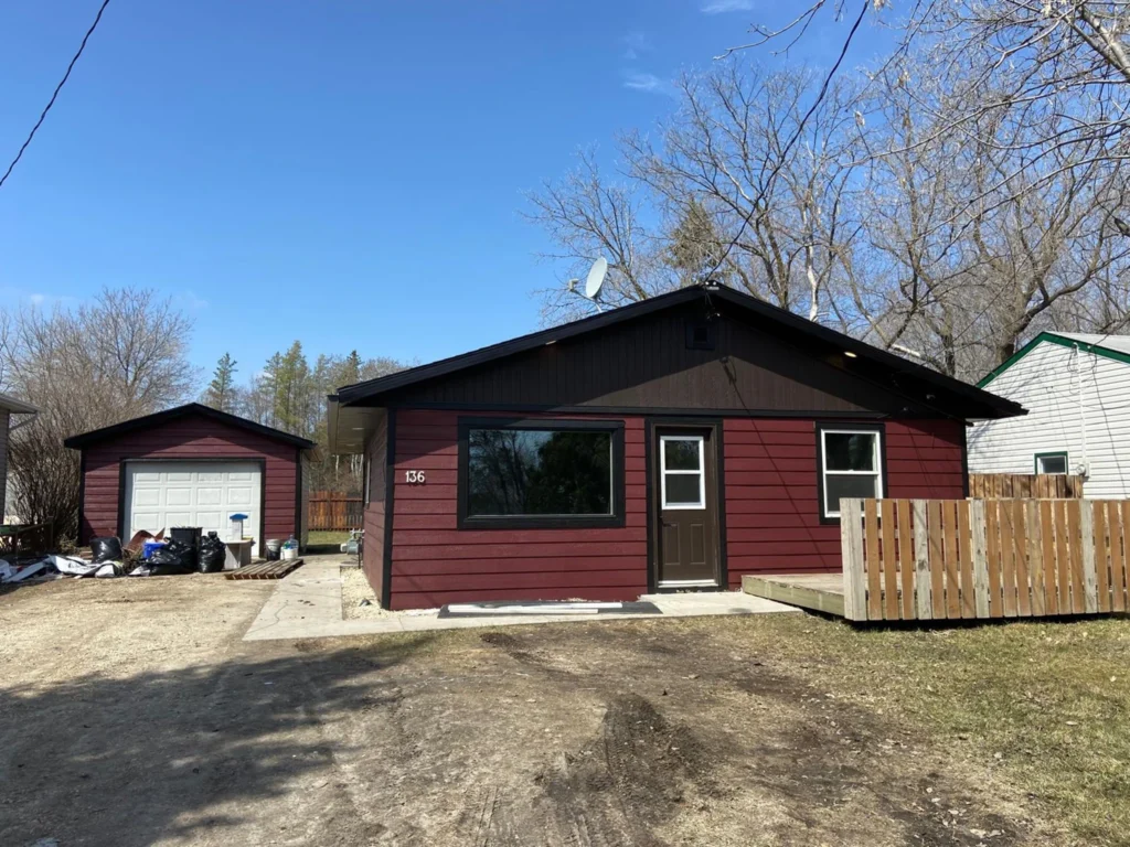 Newly renovated house exterior with burgundy siding and black trim